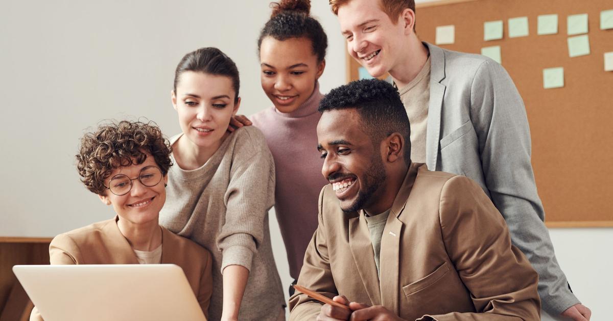A business professional reviews documents at an office desk, representing the careful preparation policyholders should bring to understanding their Personal Guarantee Insurance coverage before they need it.