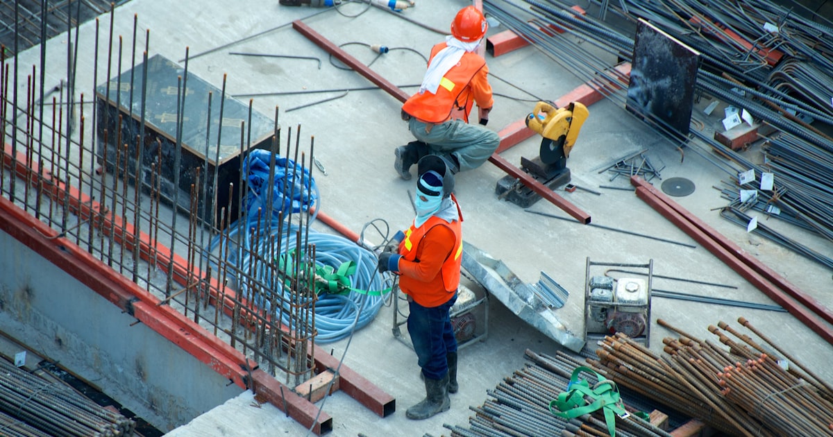 Construction supervisor on a modern job site reviewing plans